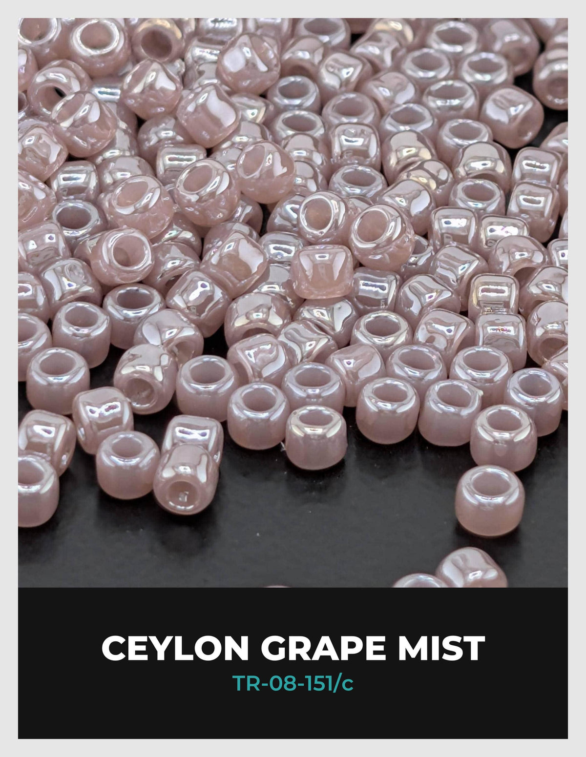 a close-up view of numerous small, round beads in shades of pink, likely pearls or grape-flavored beads.