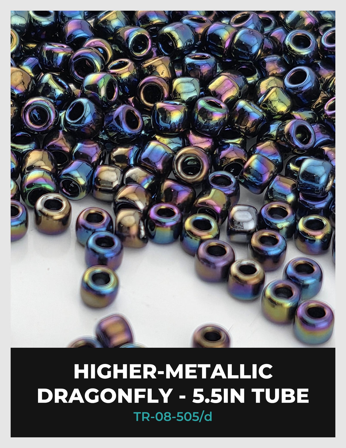 The image is a close-up of a collection of metallic beads, specifically dragonfly beads, with a focus on their iridescent colors and patterns.