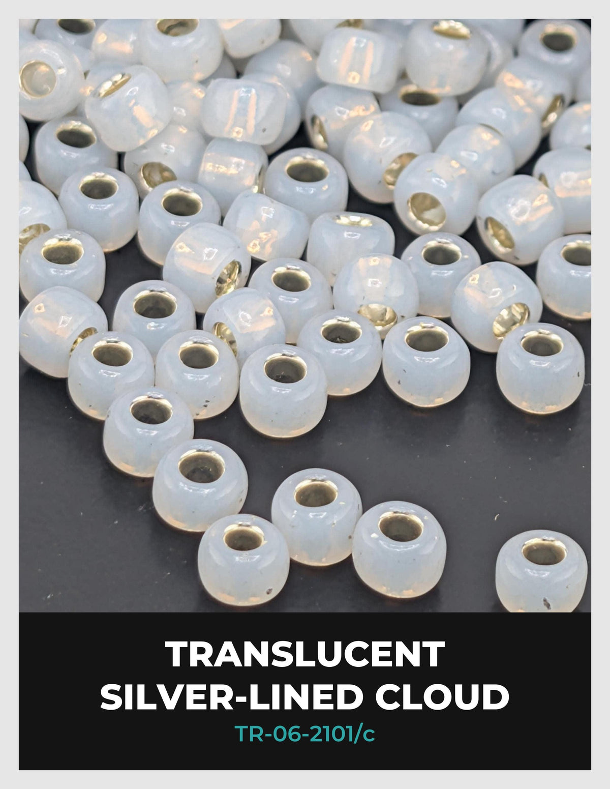 a collection of white, transparent beads with gold accents, arranged on a dark background.
