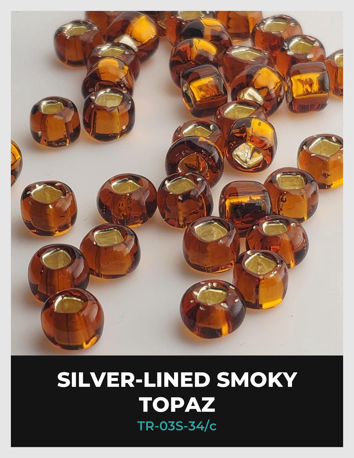 a collection of small, round, amber-colored glass beads arranged on a white background.