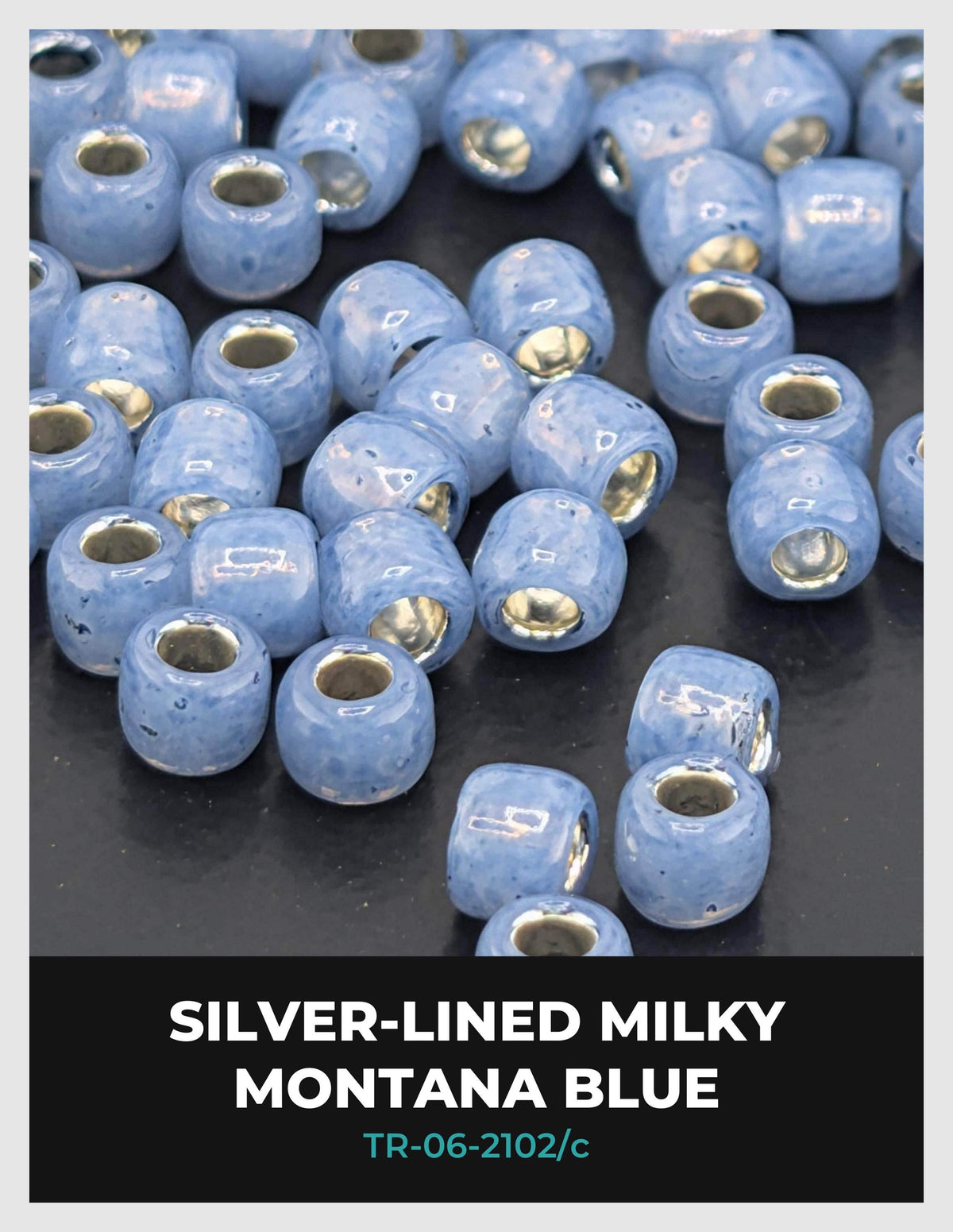 a collection of small, round beads in various shades of blue, arranged on a dark surface.