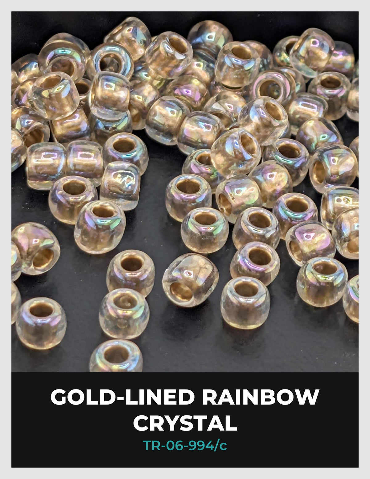 a collection of clear, iridescent glass beads scattered on a dark background.