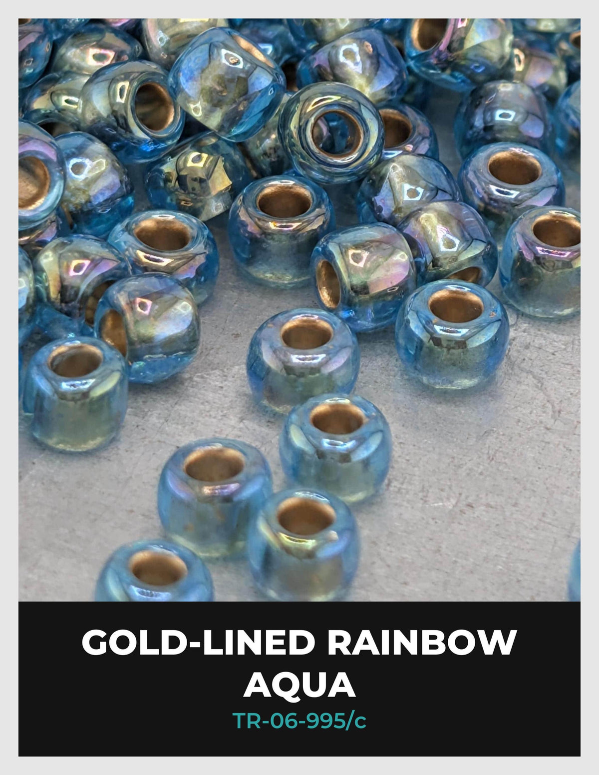 a collection of small, round, blue glass beads arranged on a surface, with some of them appearing to be gold-colored.