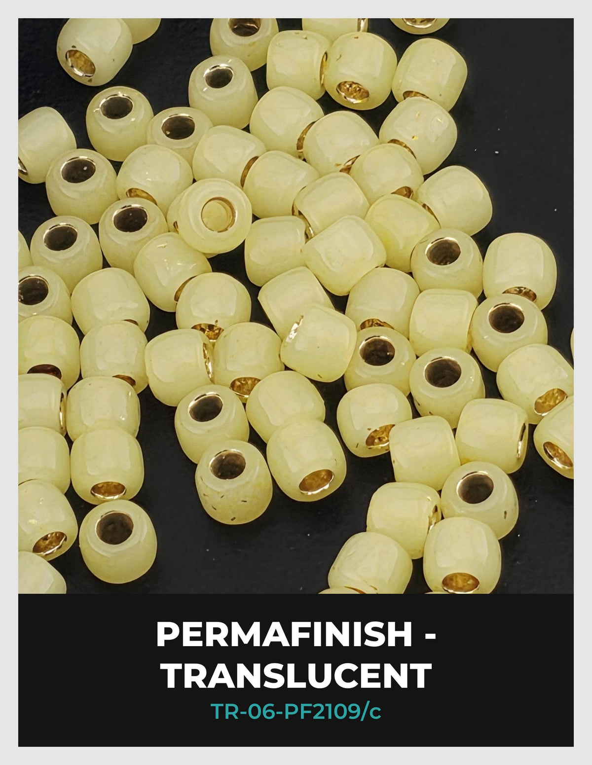 a collection of small, white beads with gold accents, arranged on a dark background.