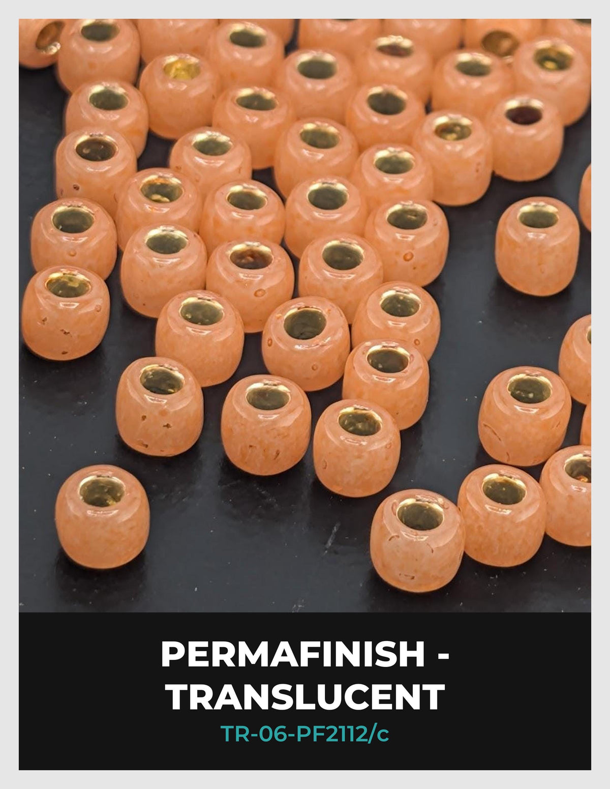 a collection of small, round beads in a variety of colors, including orange and yellow, arranged on a dark surface.