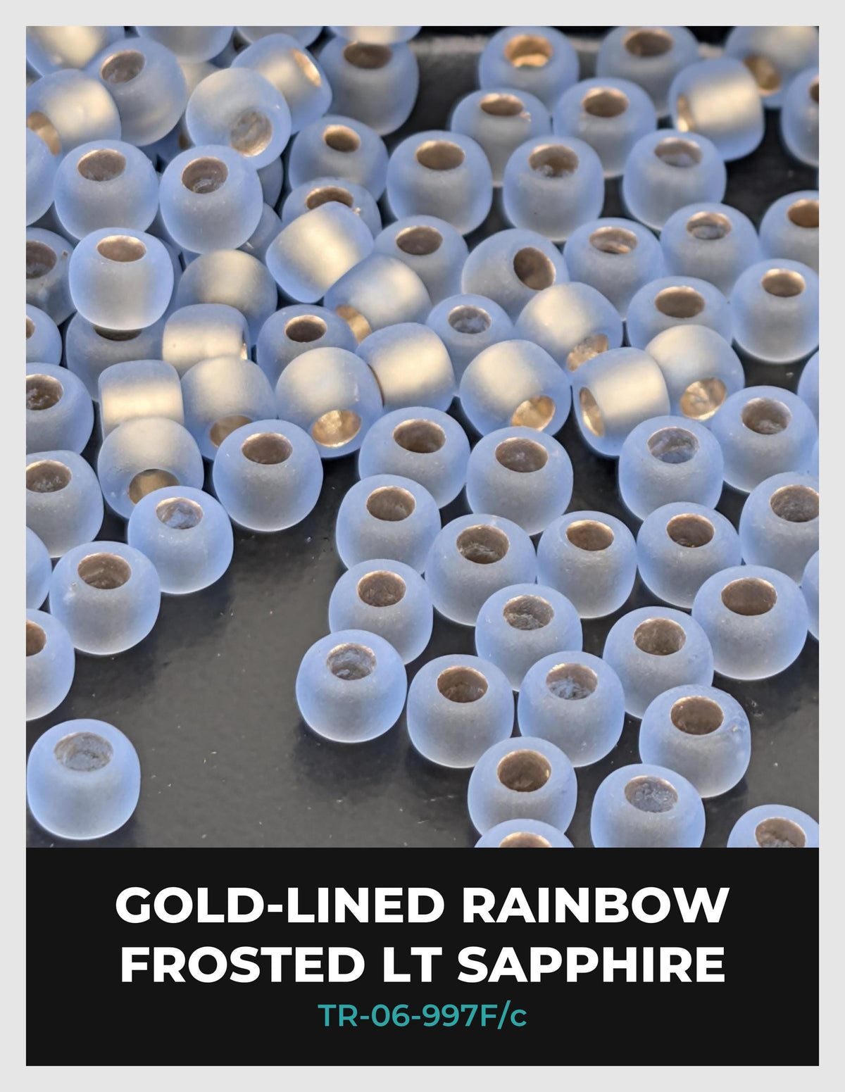 a collection of small, clear, frosted, and gold-colored beads or stones scattered across a dark background.