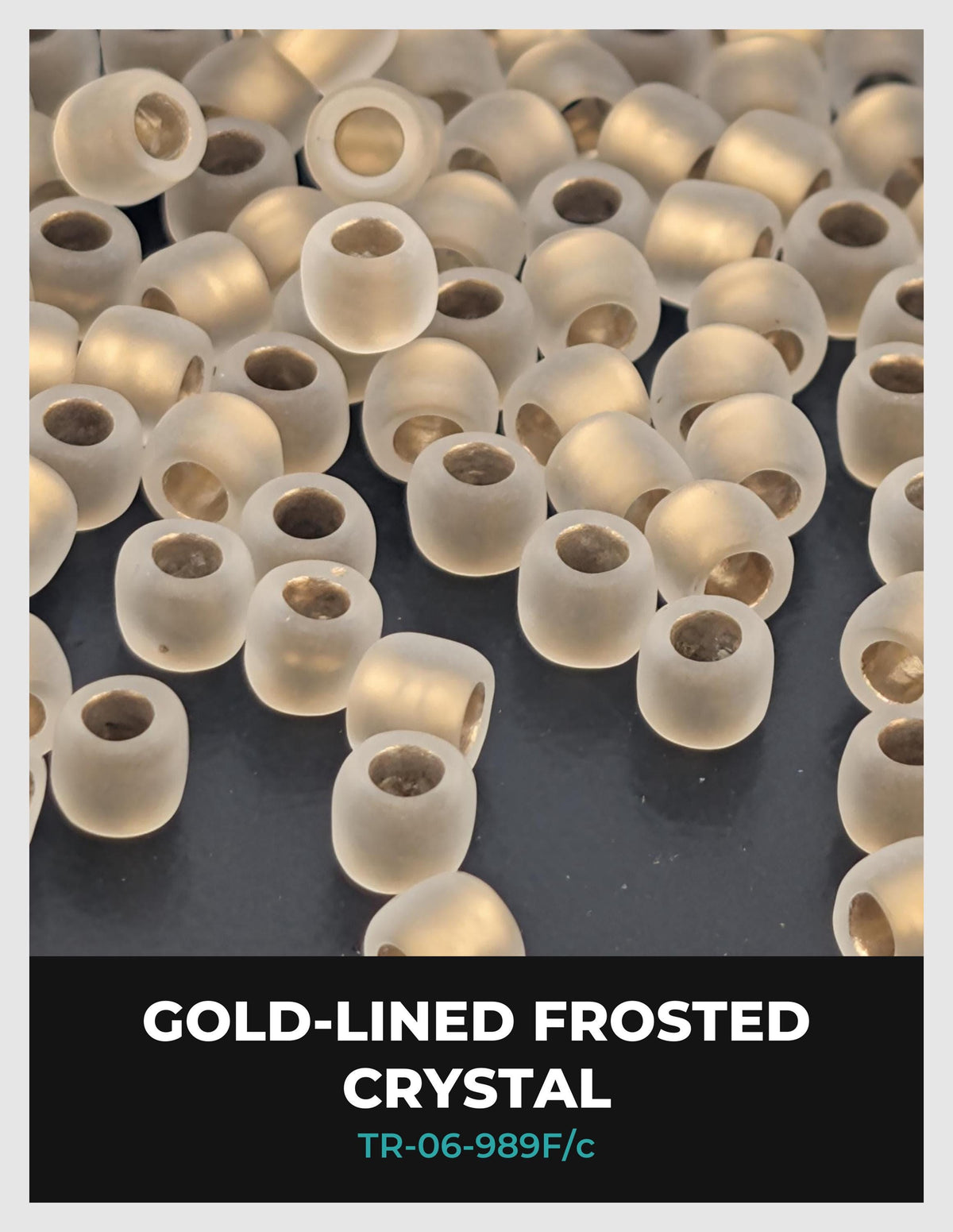 a collection of small, clear crystal beads or beads with a gold-colored lining, scattered across a dark background.