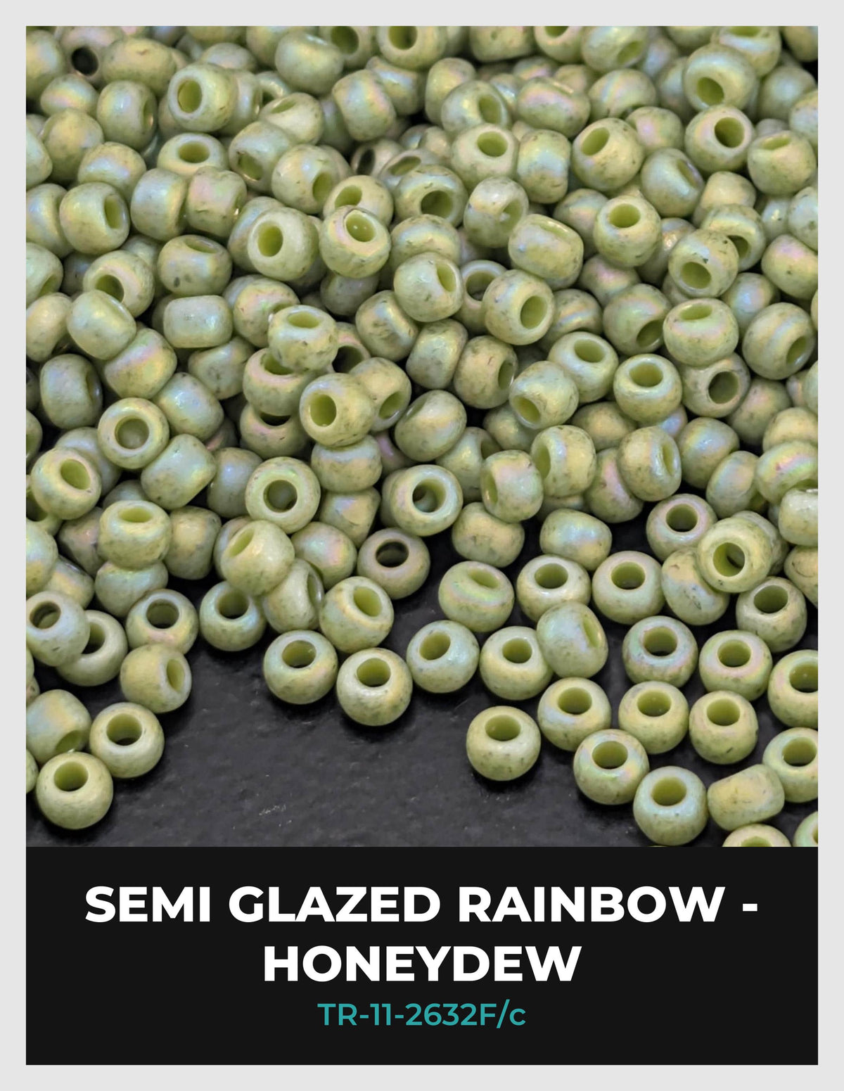 a large pile of semi-glazed rainbow-colored beads, likely made of glass, on a dark surface.