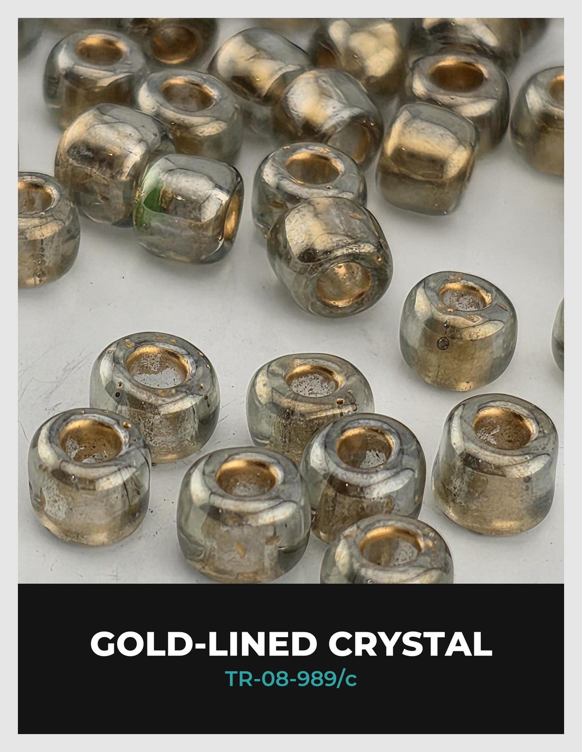 a collection of gold-lined crystal beads scattered across a white background.