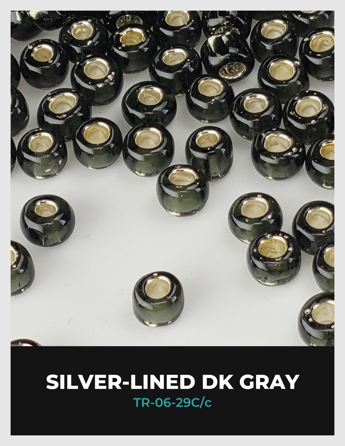a collection of black and silver-colored beads arranged on a white background.