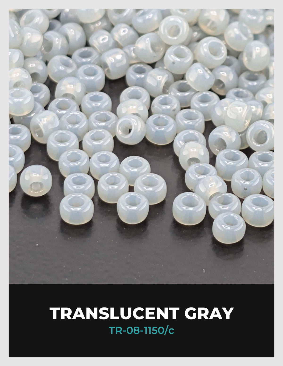 a collection of small, white, translucent beads scattered on a dark surface.