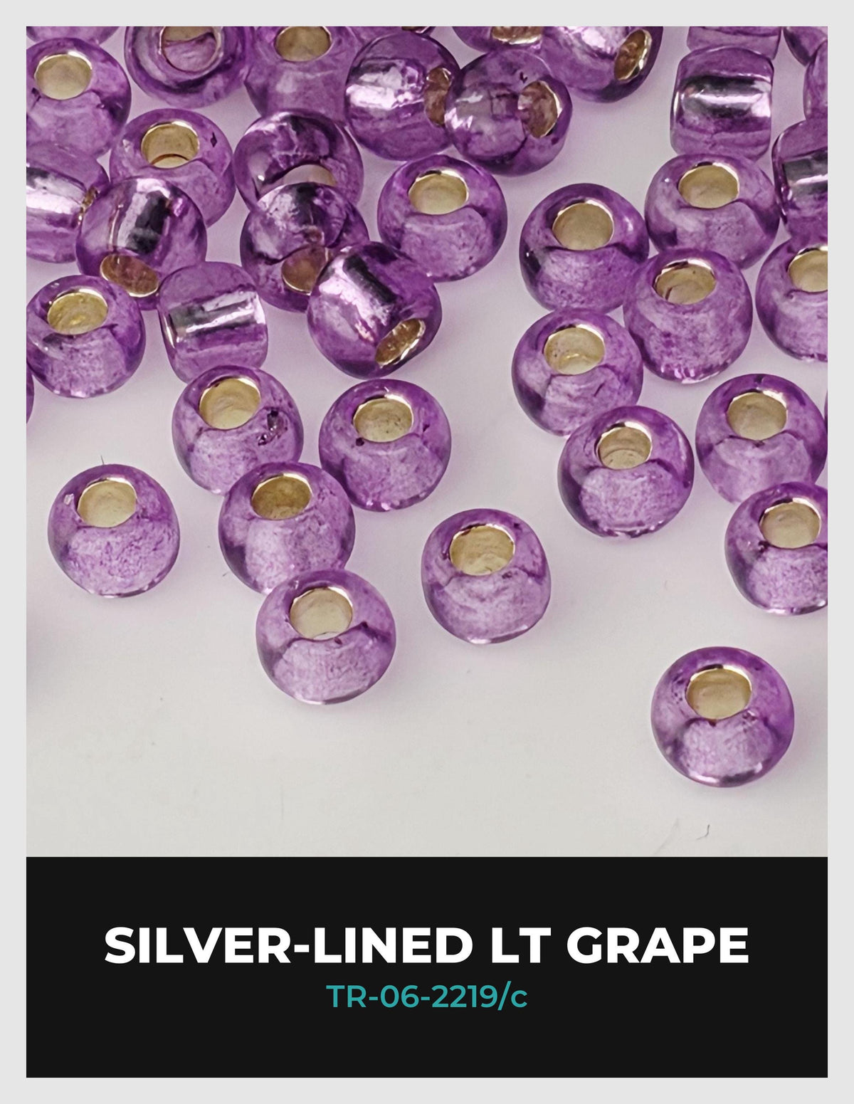 a collection of purple glass beads with gold accents, arranged in a scattered pattern.