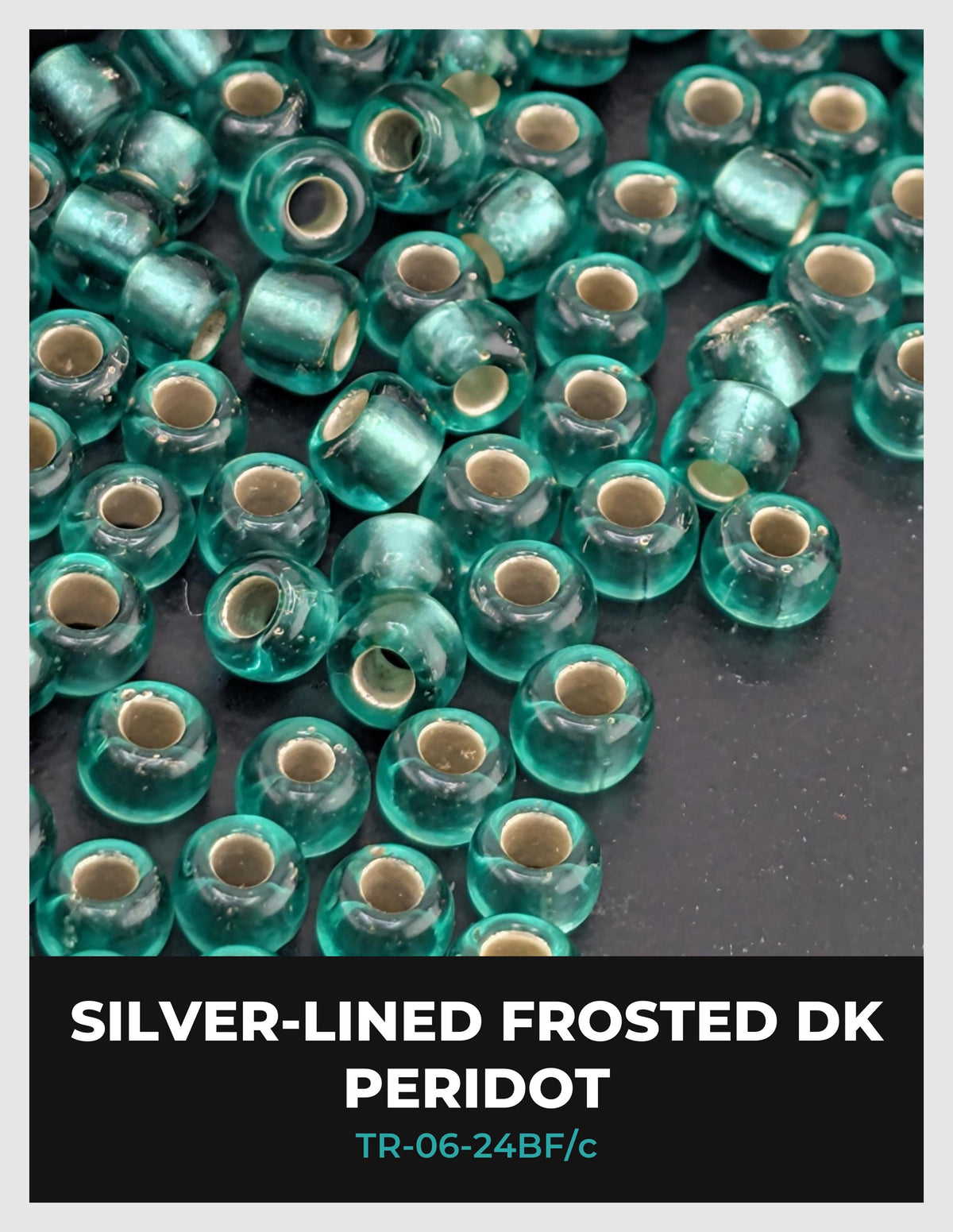 a collection of small, clear glass beads in various shades of green, arranged in a visually appealing manner.