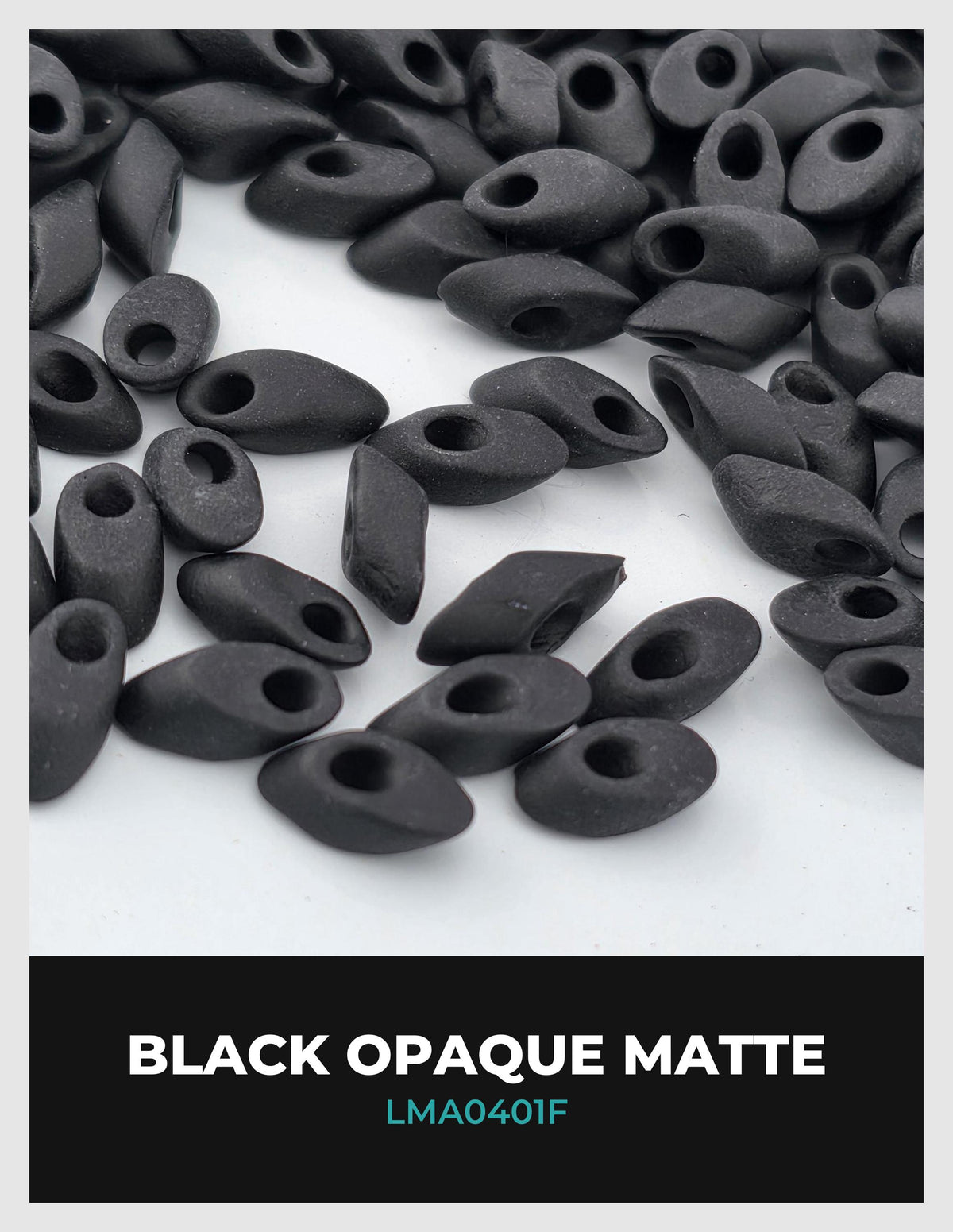 a collection of black opaque matte beads or stones scattered on a white background.