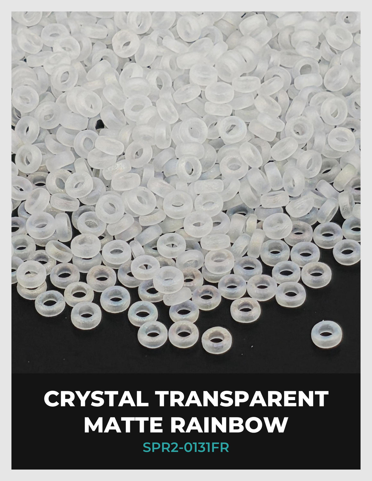 The image is a close-up of numerous transparent, clear plastic beads scattered on a dark background.