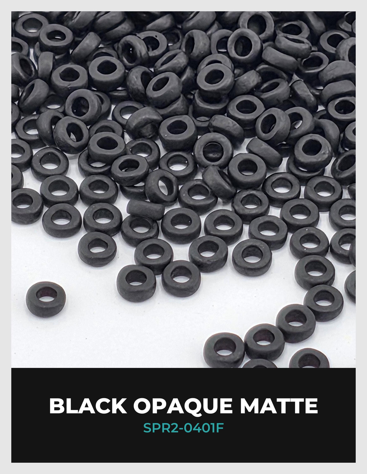 a large pile of black rubber or plastic objects, such as tires or nuts, scattered across a white background.