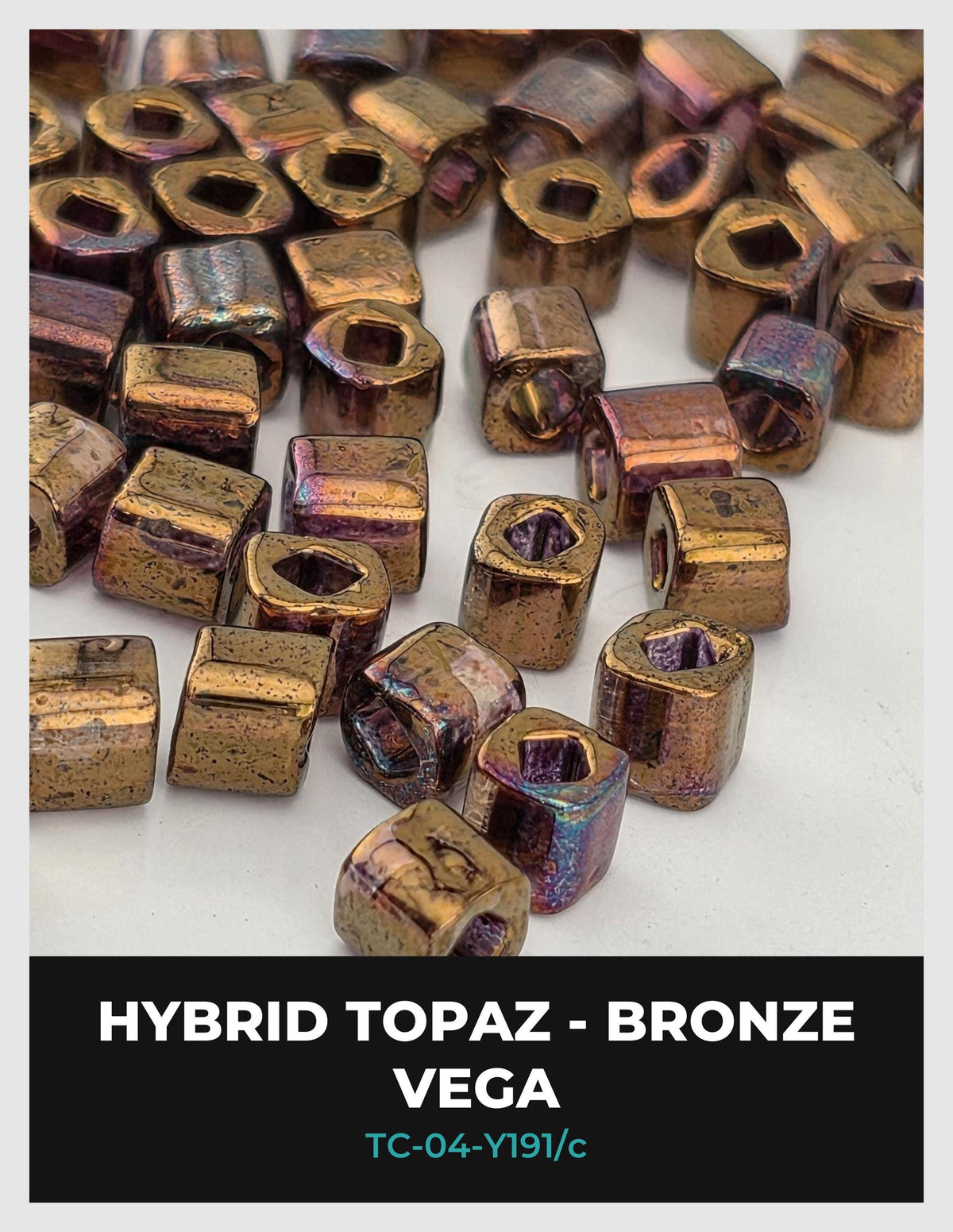 a collection of metallic beads, including topaz and bronze, scattered on a white background.