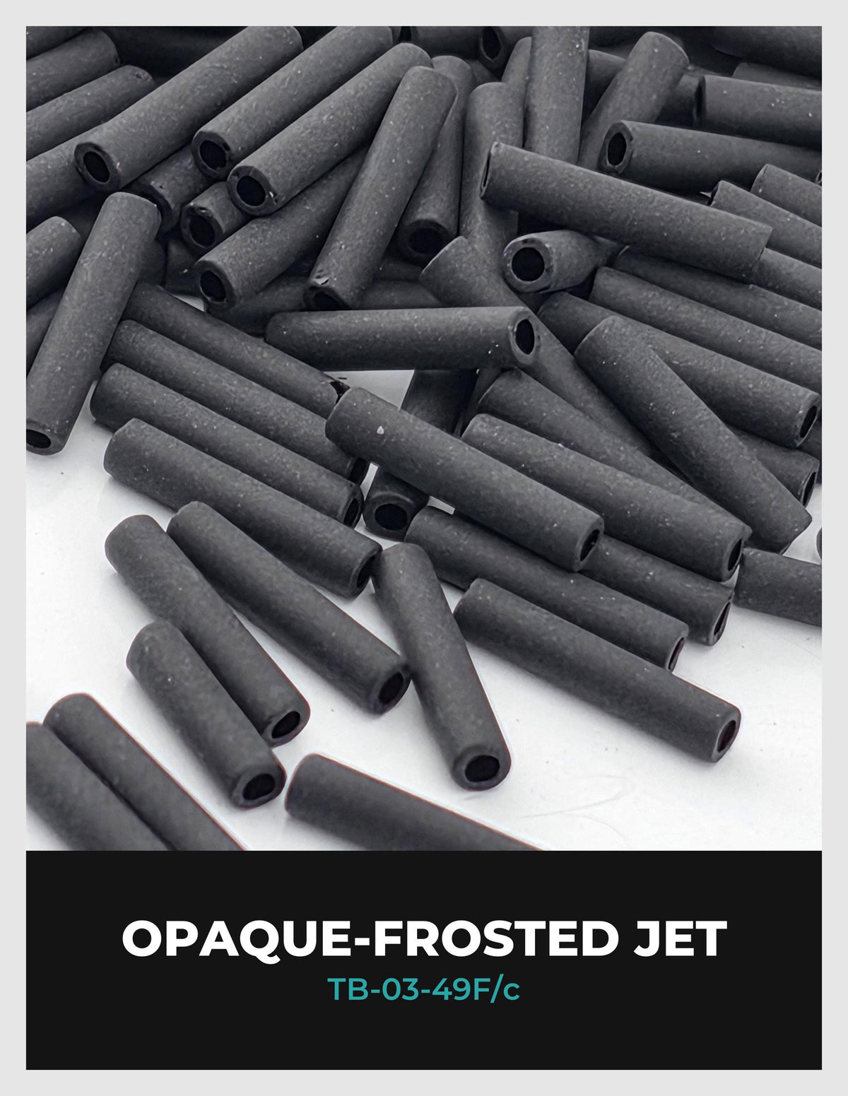 a pile of black cylindrical objects, possibly metal pipes or tubes, with a frosted or polished appearance.