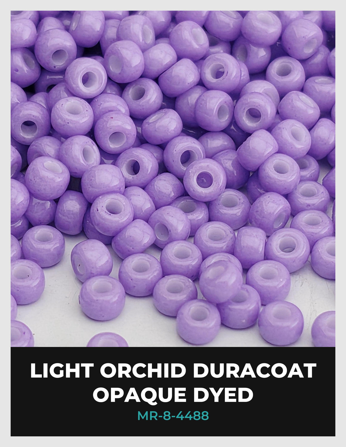a large pile of purple beads, likely made of glass or plastic, scattered on a surface.