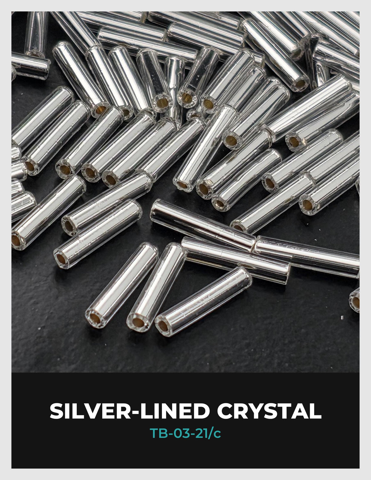 a collection of silver-lined crystal beads scattered on a dark surface.