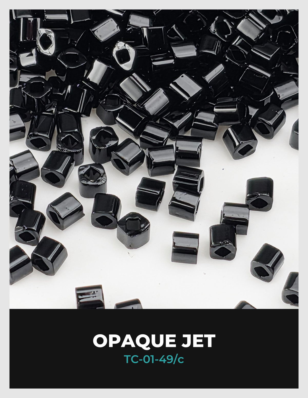 The image is a close-up of numerous black hexagonal objects, possibly beads or nuts, scattered across a white background.
