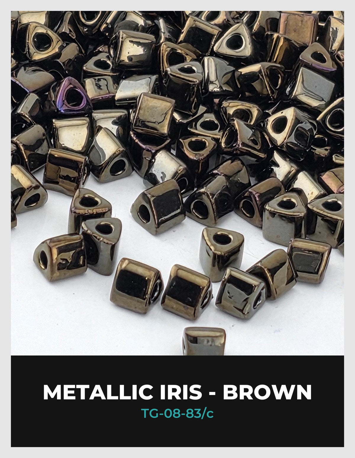 a collection of metallic iridescent beads in various shades of brown, scattered across a white background.