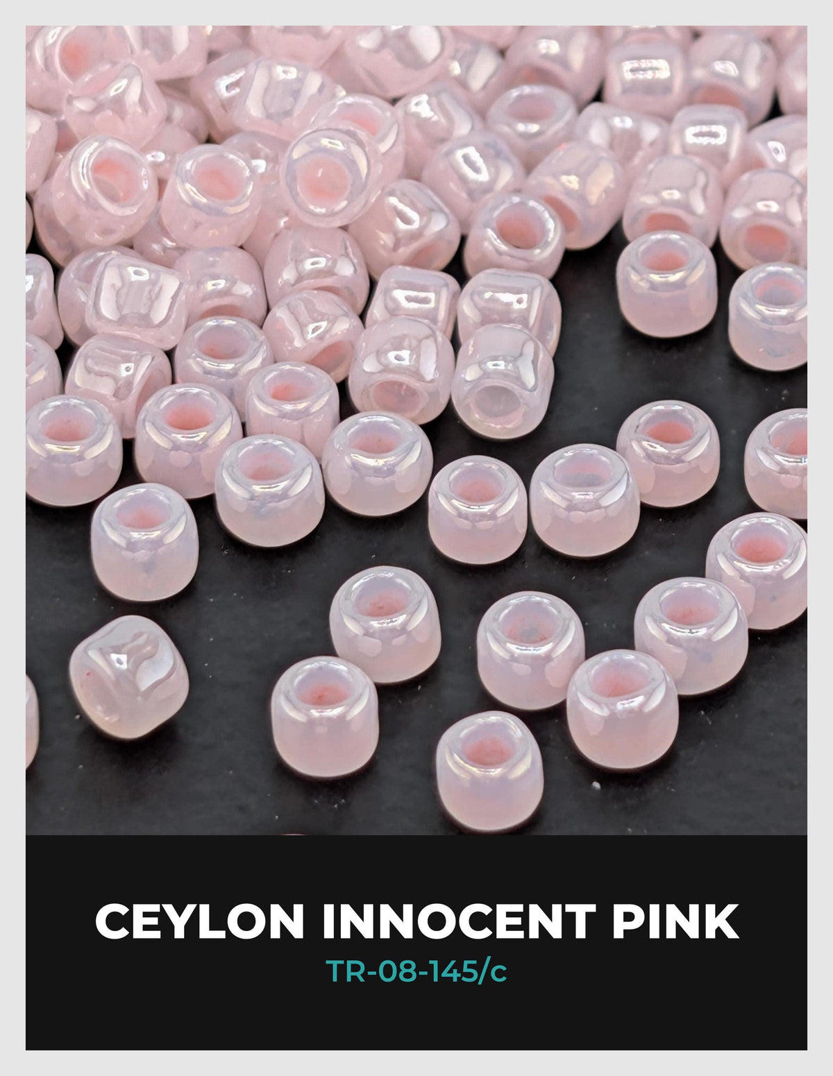a collection of small, clear beads in various shades of pink, scattered on a dark background.