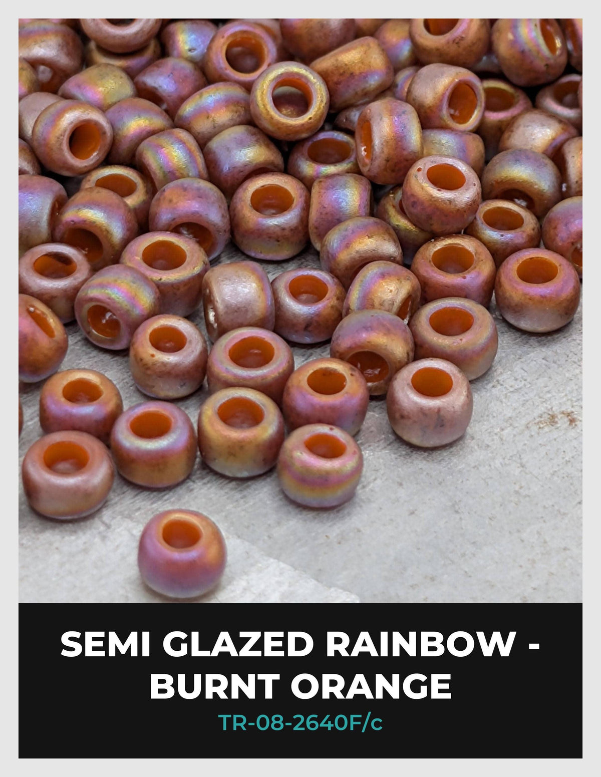 a collection of semi-glazed rainbow-colored beads, including burnt orange and burnt red, scattered on a surface.