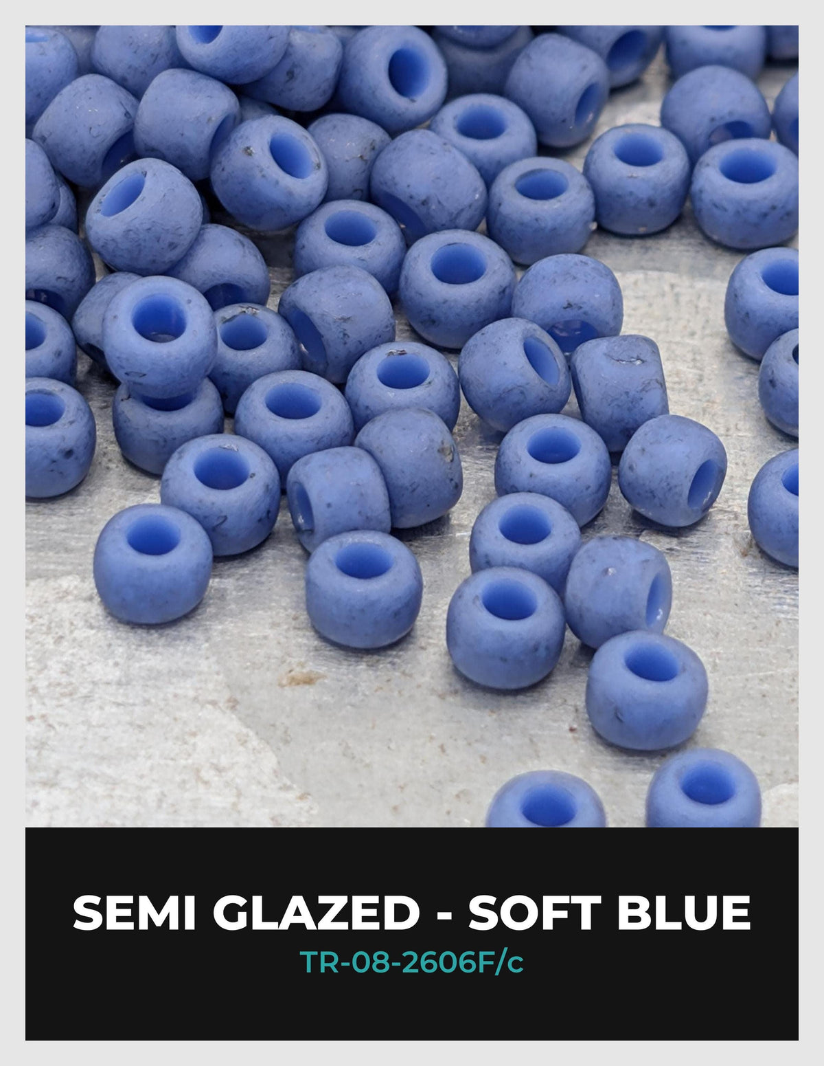 a collection of semi-glazed, soft blue beads scattered on a surface.