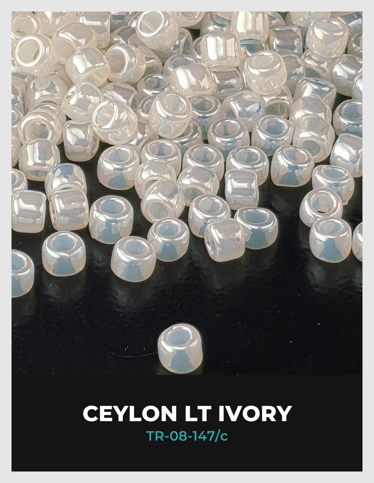 a collection of small, clear, white beads scattered on a dark background.