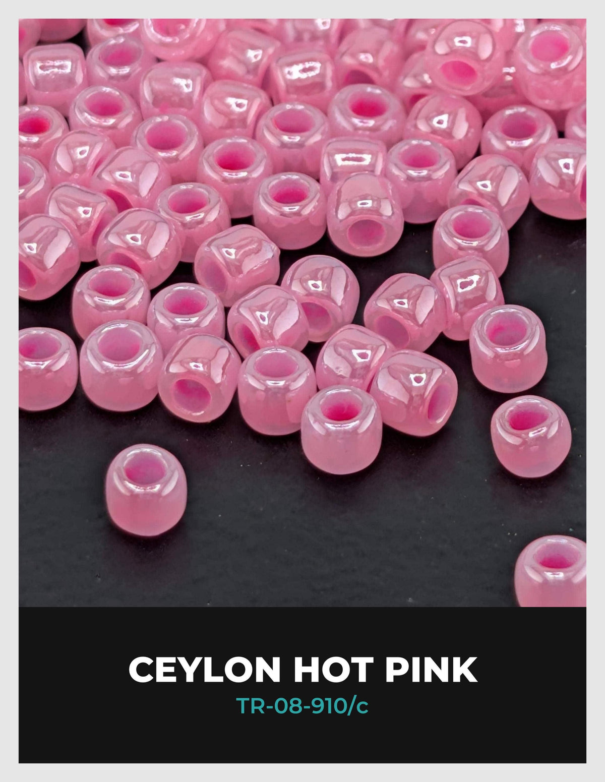 a collection of small, round, pink beads scattered on a dark background.