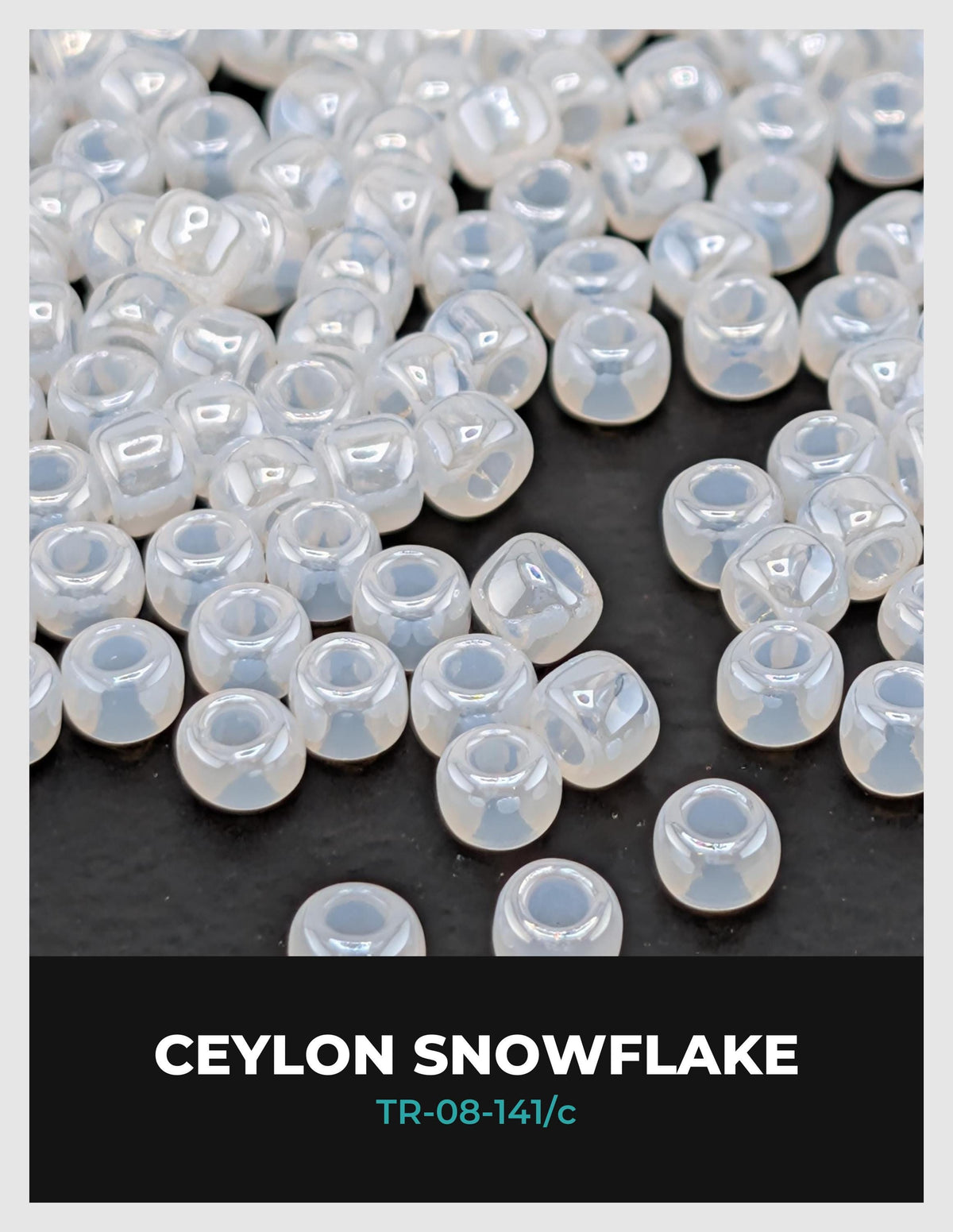 a collection of small, clear, white beads scattered on a dark background.