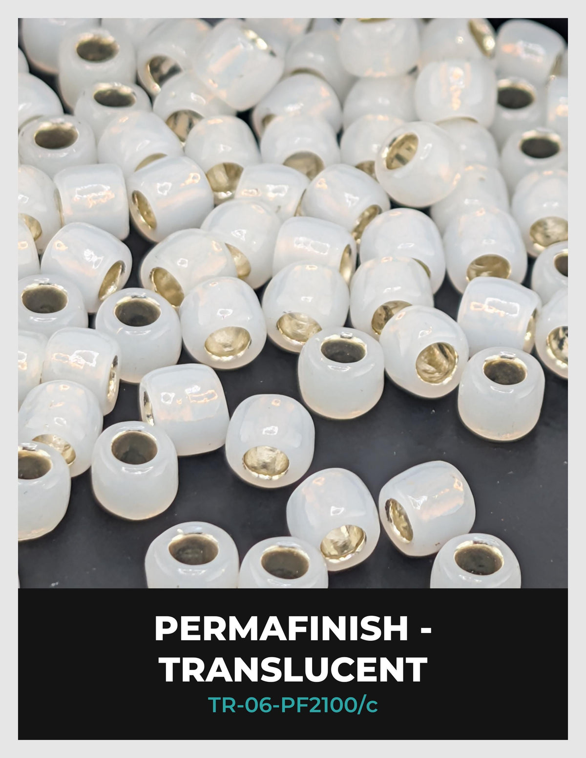 a collection of white, transparent beads scattered on a dark background.