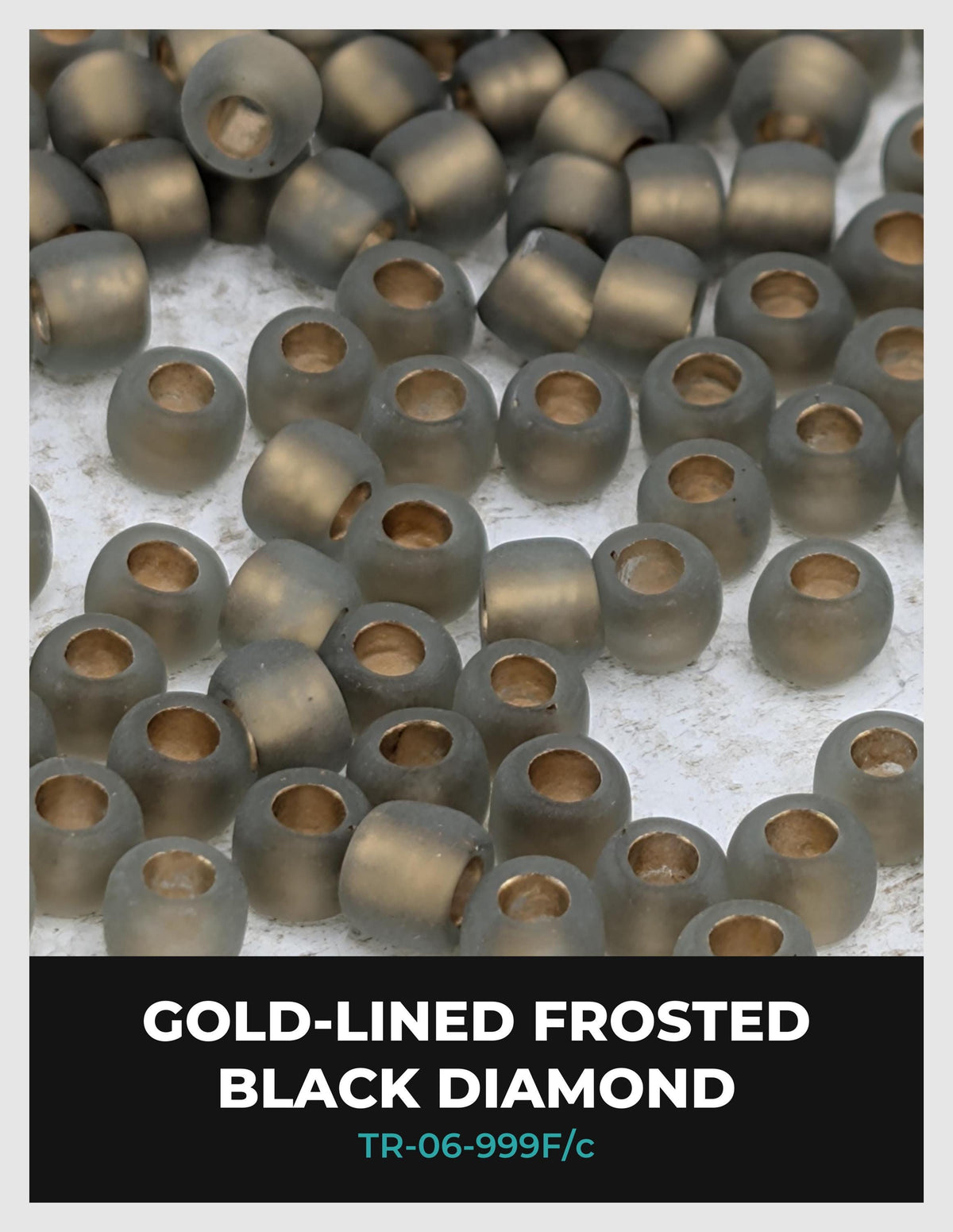 a collection of black diamond-shaped beads, some of which are gold-lined and frosted, scattered across a surface.