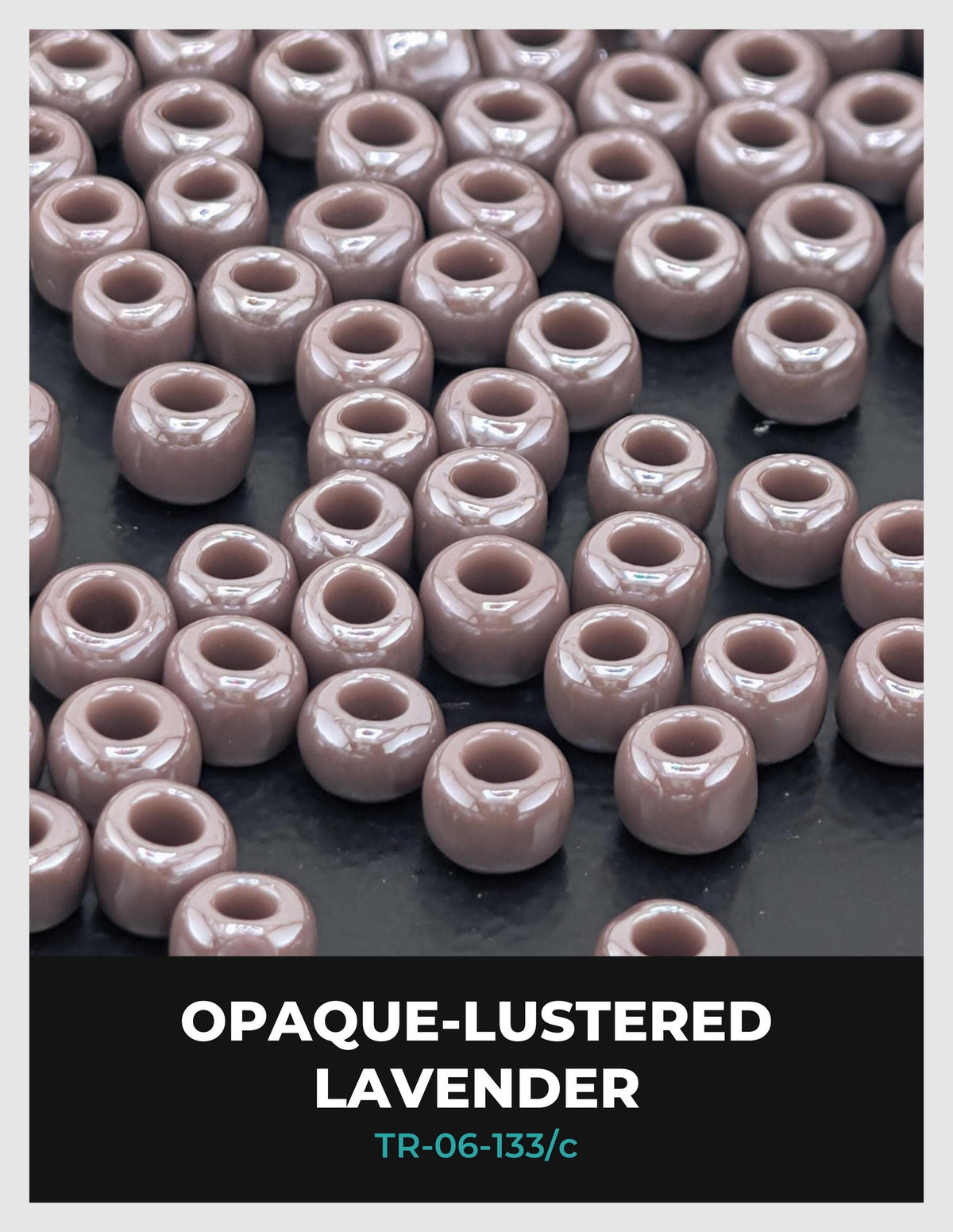 a collection of small, round beads in various shades of pink, arranged in a grid-like pattern on a dark background.