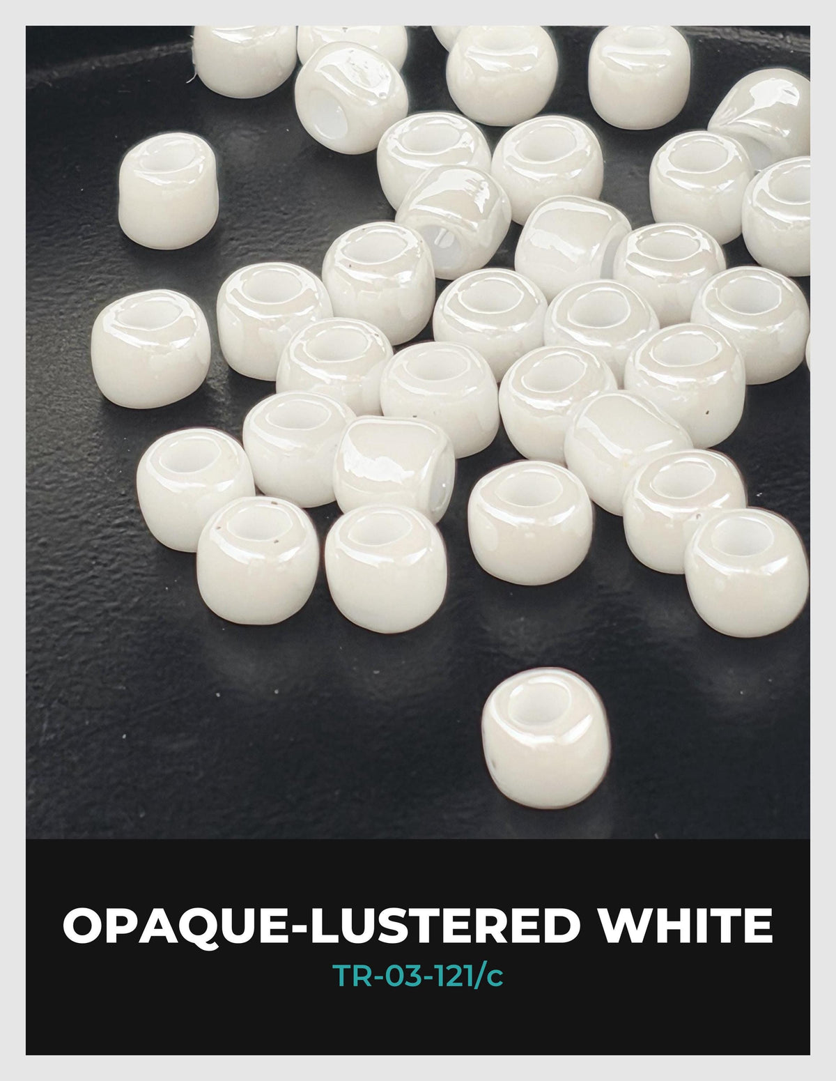 a collection of white, round beads scattered on a dark surface.