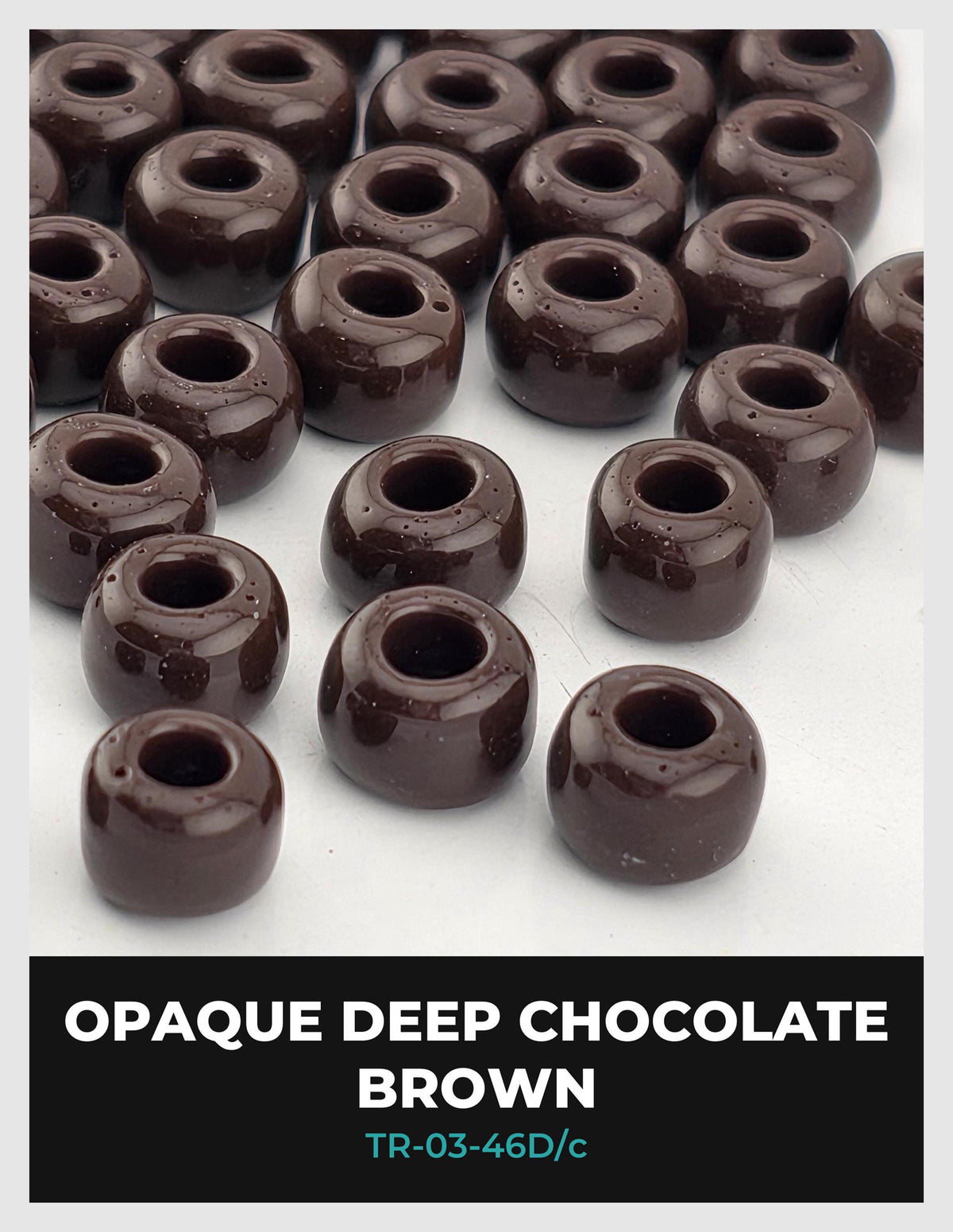 a collection of chocolate-covered chocolate balls, specifically deep chocolate brownies, arranged on a white surface.