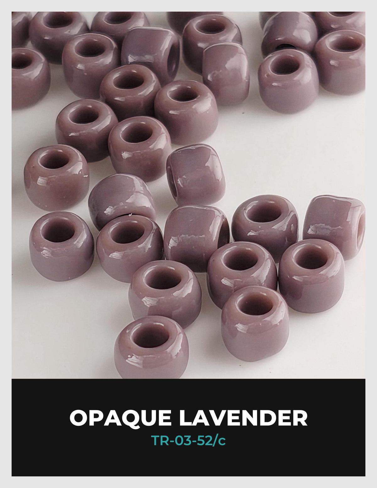a collection of small, round, purple beads arranged on a white background.