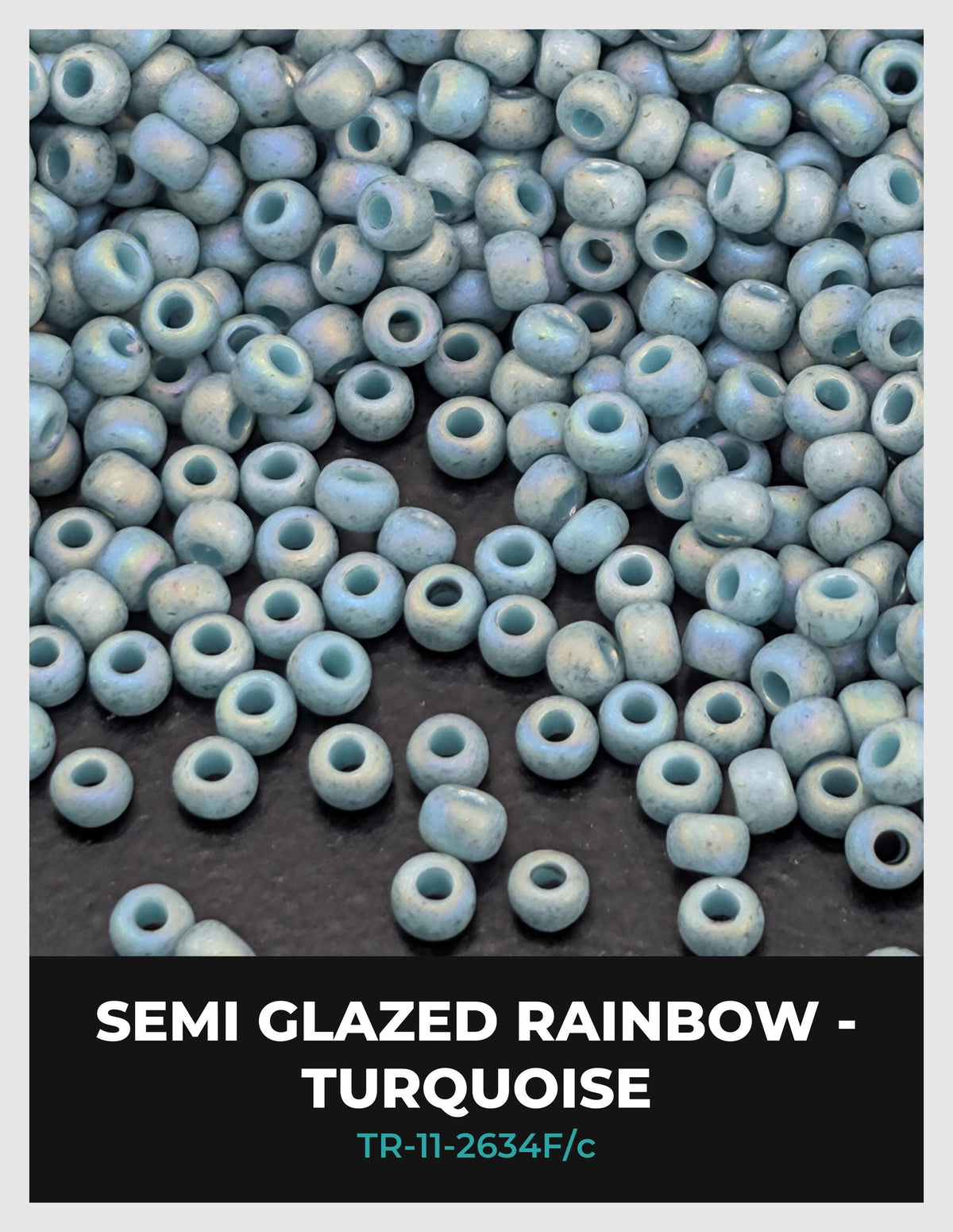 a large pile of semi-glazed rainbow-colored turquoise beads scattered on a dark surface.