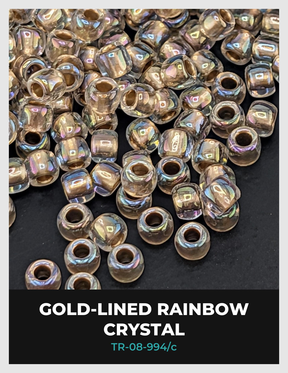 a collection of gold-colored, rainbow-colored crystal beads scattered on a dark background.