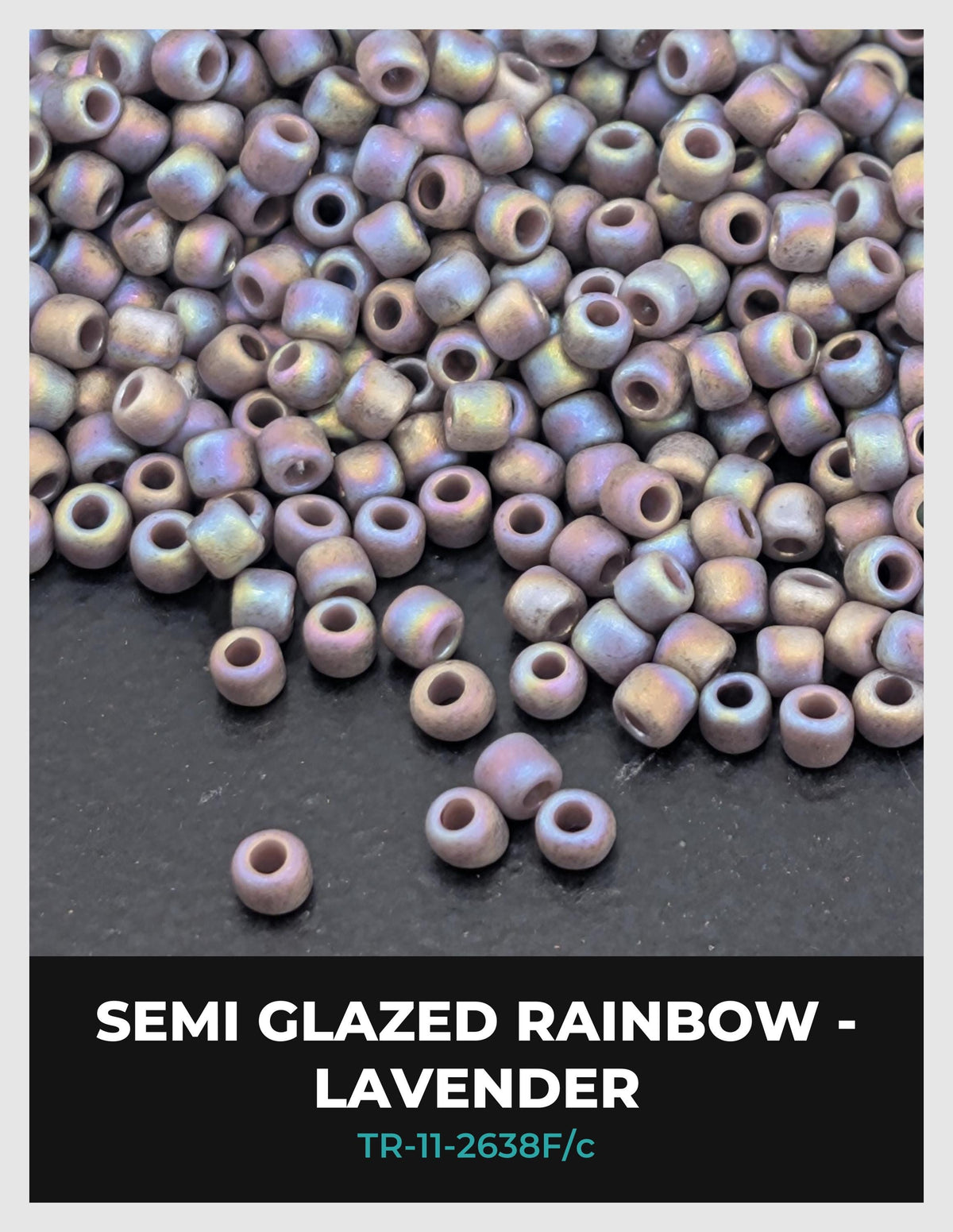 a pile of semi-glazed rainbow beads, specifically lavender beads, scattered on a dark surface.
