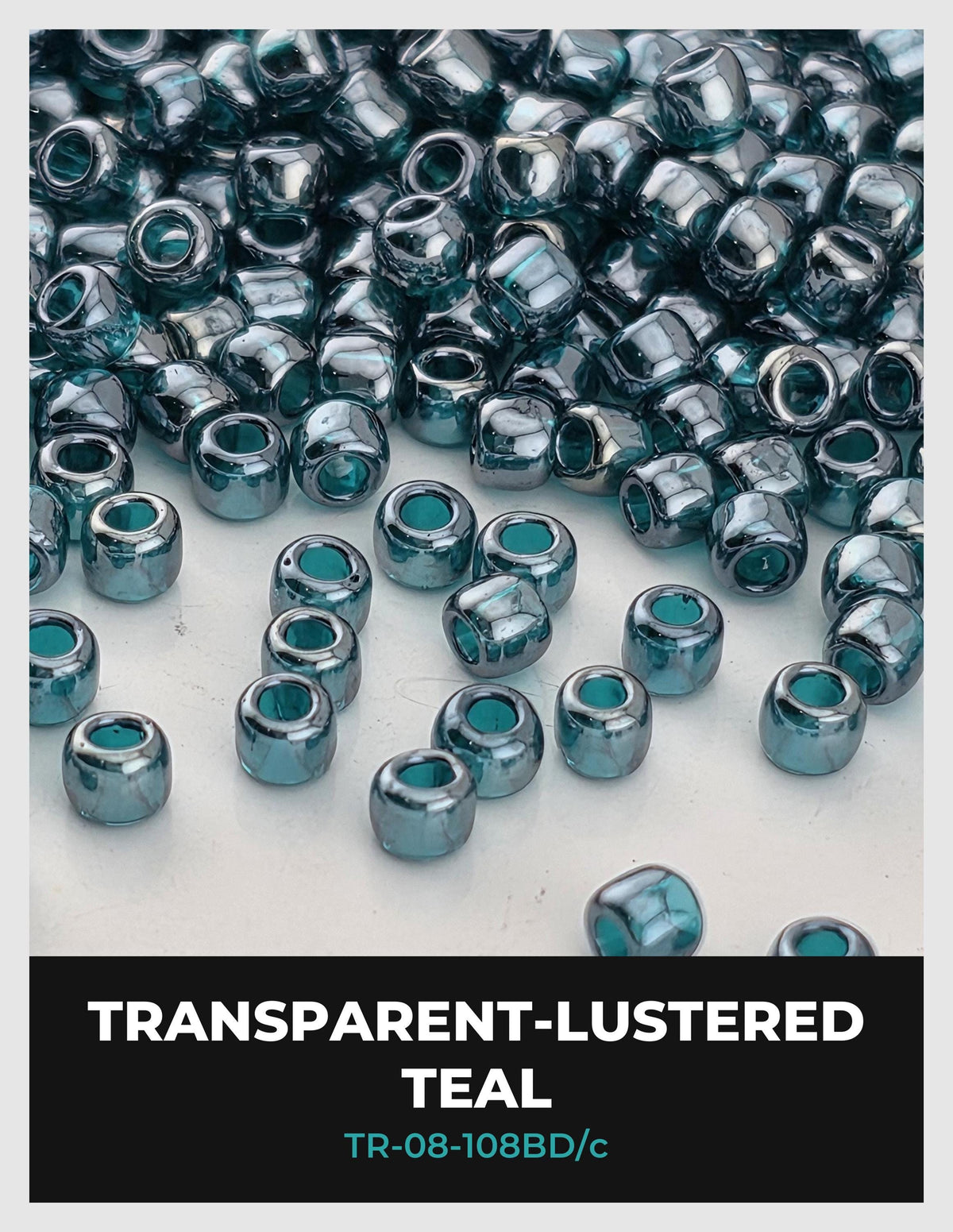 a collection of small, clear beads in various shades of blue, scattered across a white background.