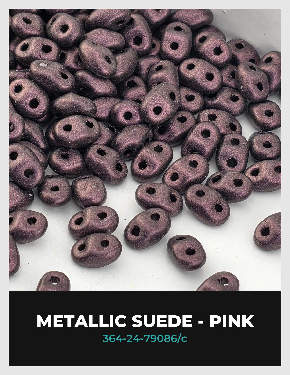 a collection of small, round, metallic beads in shades of purple, scattered across a white background.