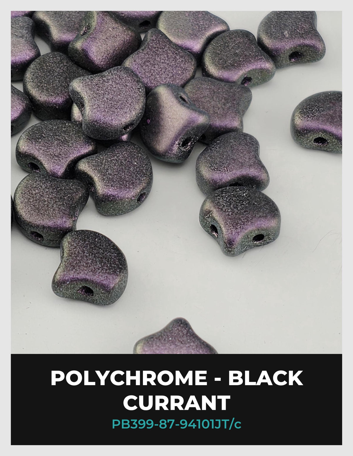 a collection of black, purple, and silver beads scattered on a white background.
