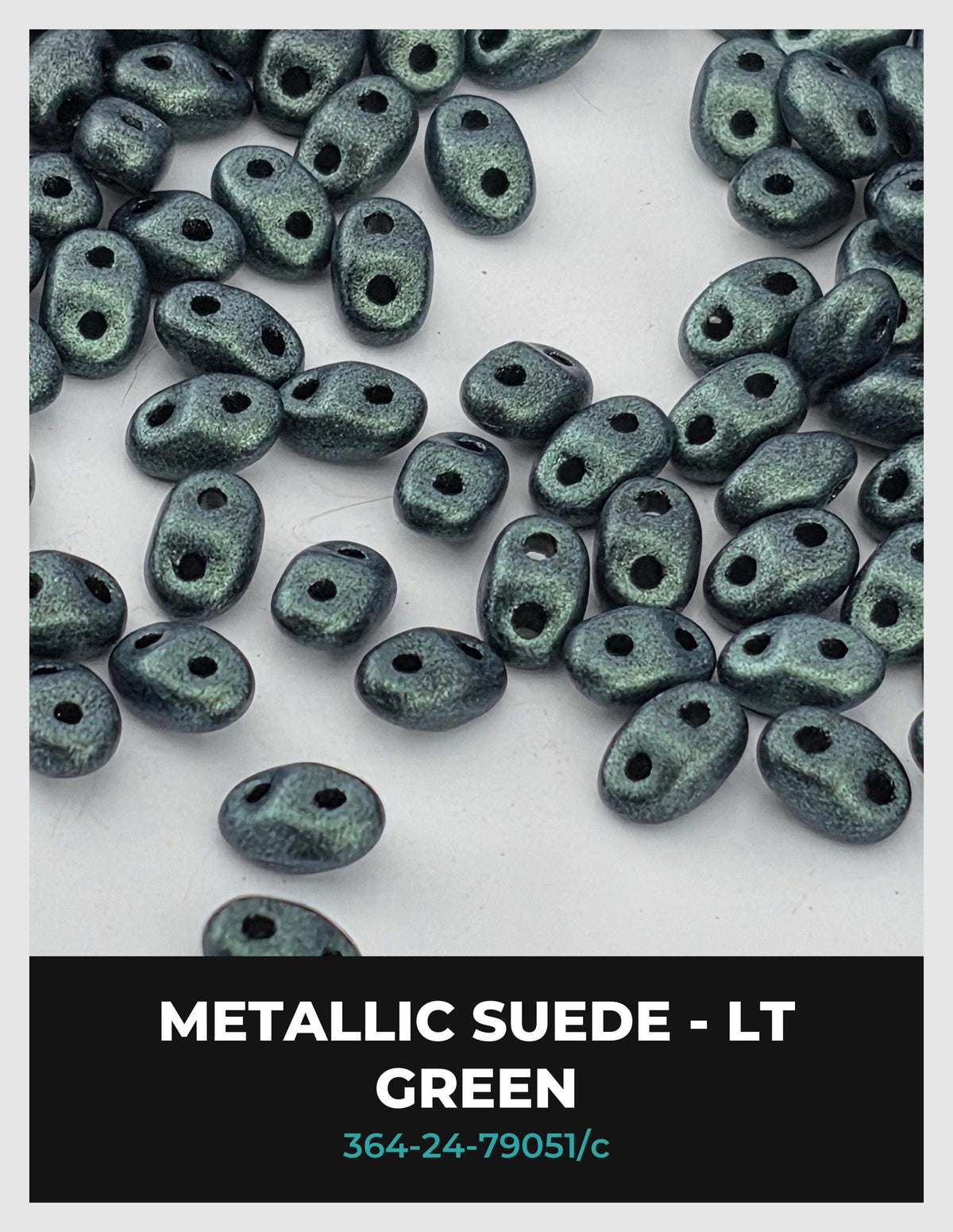 a collection of metallic green beads or stones scattered on a white background.