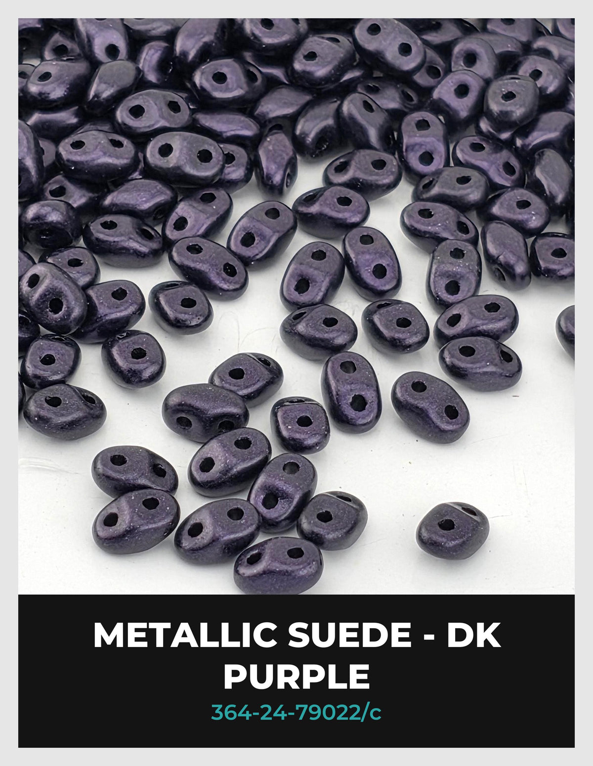 a collection of small, purple beads scattered on a white background.