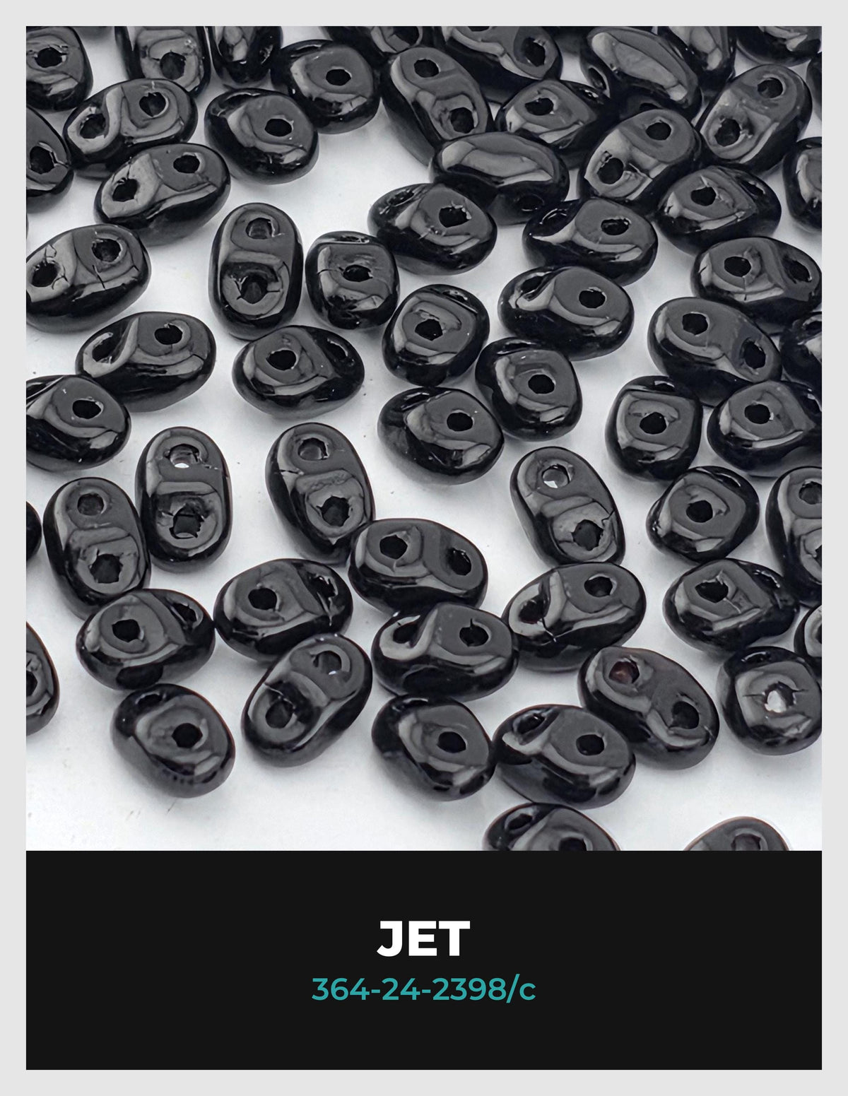 a collection of black beads or beads arranged in a pattern, with the word "JET" written in the center.